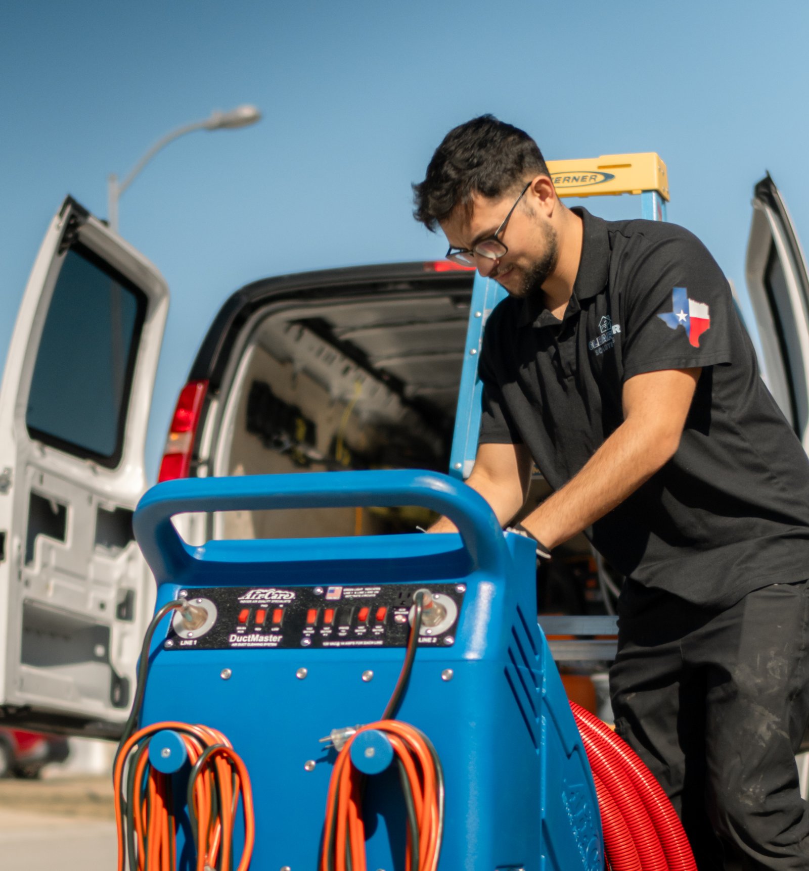 ClearAir Solutions technician with professional DuctMaster equipment at service van in Pasadena