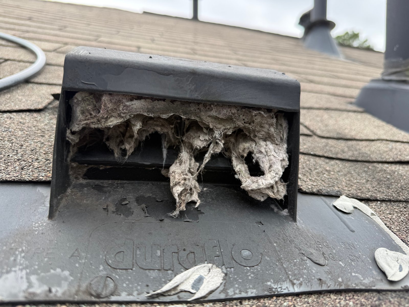 Long flexible dryer vent running through an attic in a two-story Katy home
