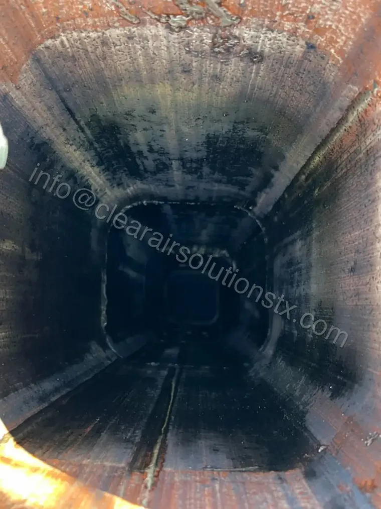Clay flue tile inside a chimney before creosote removal