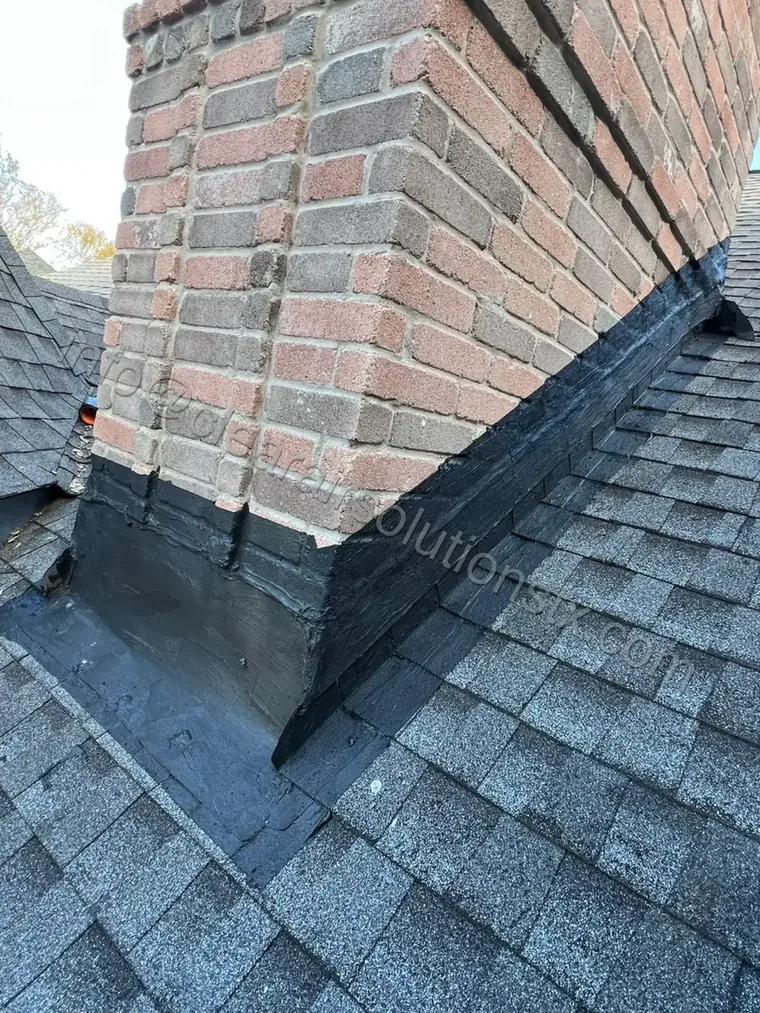 New chimney flashing sealed where the chimney meets the roof in Houston, TX