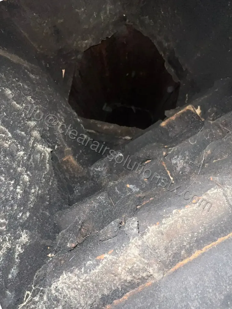 Heavy creosote and soot inside a chimney flue before cleaning in Houston, TX